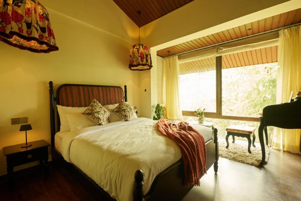 Guest room at Monkey Resort, with a large bed and a bright window